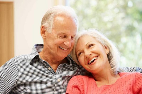 Older couple sitting together smiling